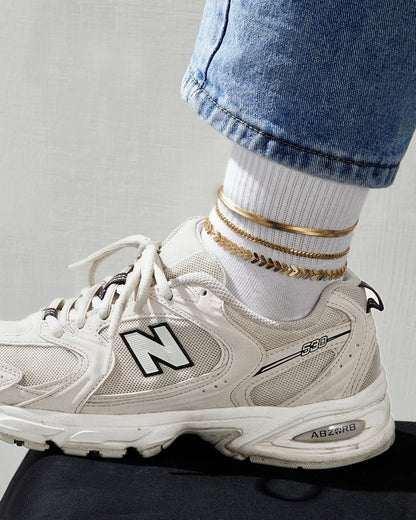 Close-up of the Fishbone, 3mm Cuban, and Snake chains on the Layering Anklet Bracelet Set